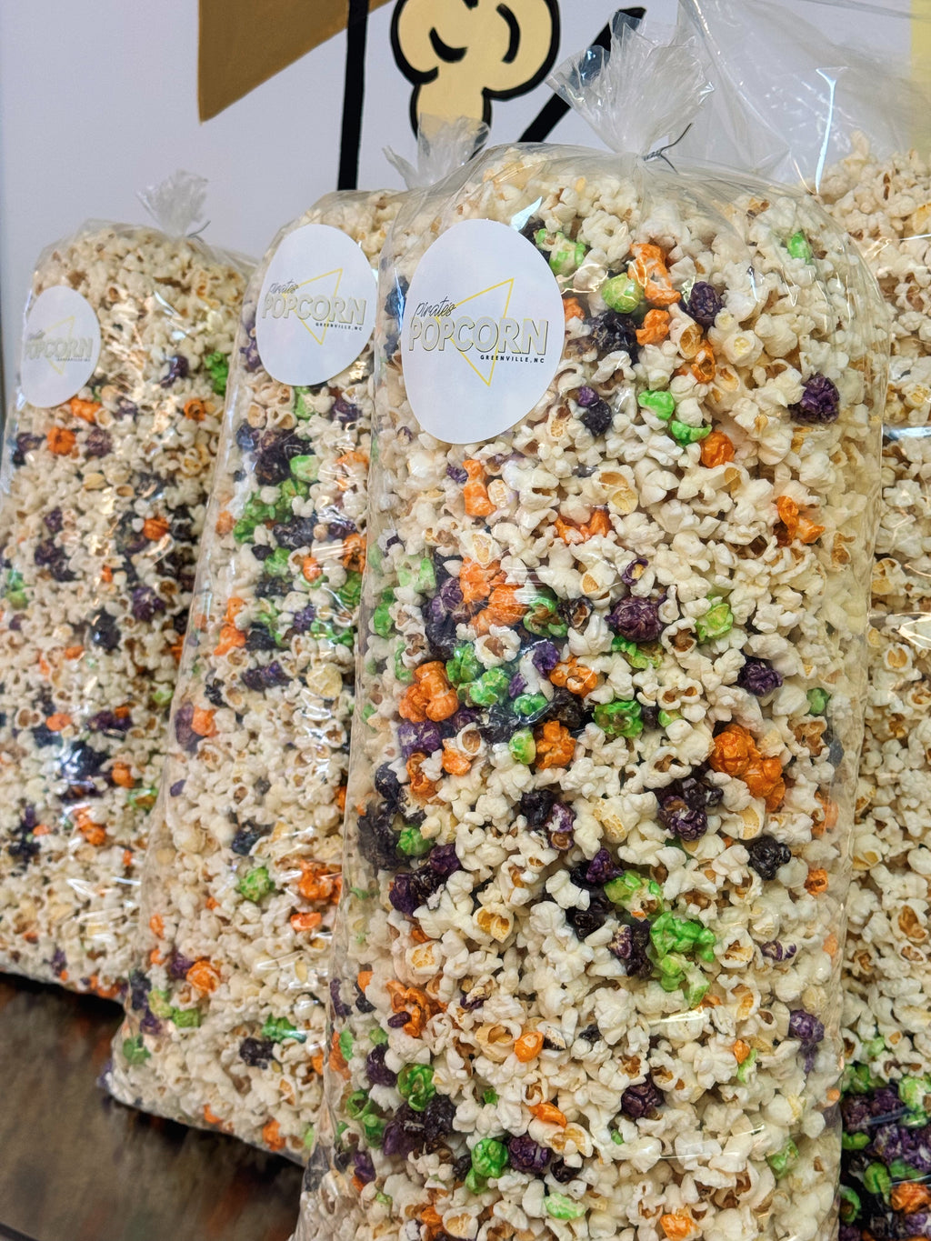 Halloween-themed popcorn bags with colorful sprinkles on a white background