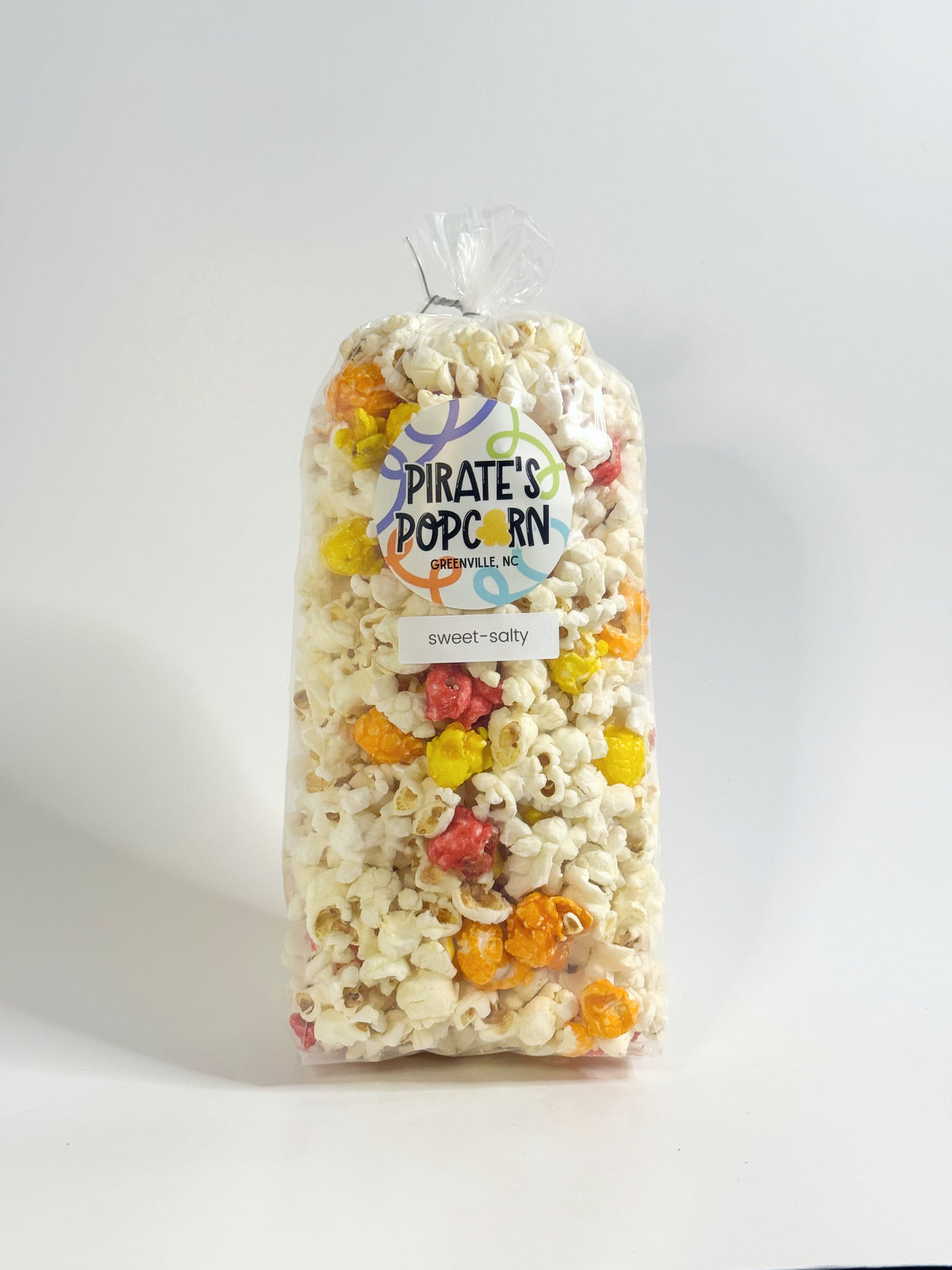 Bag of Pirate's Popcorn with colorful popcorn pieces on a white background