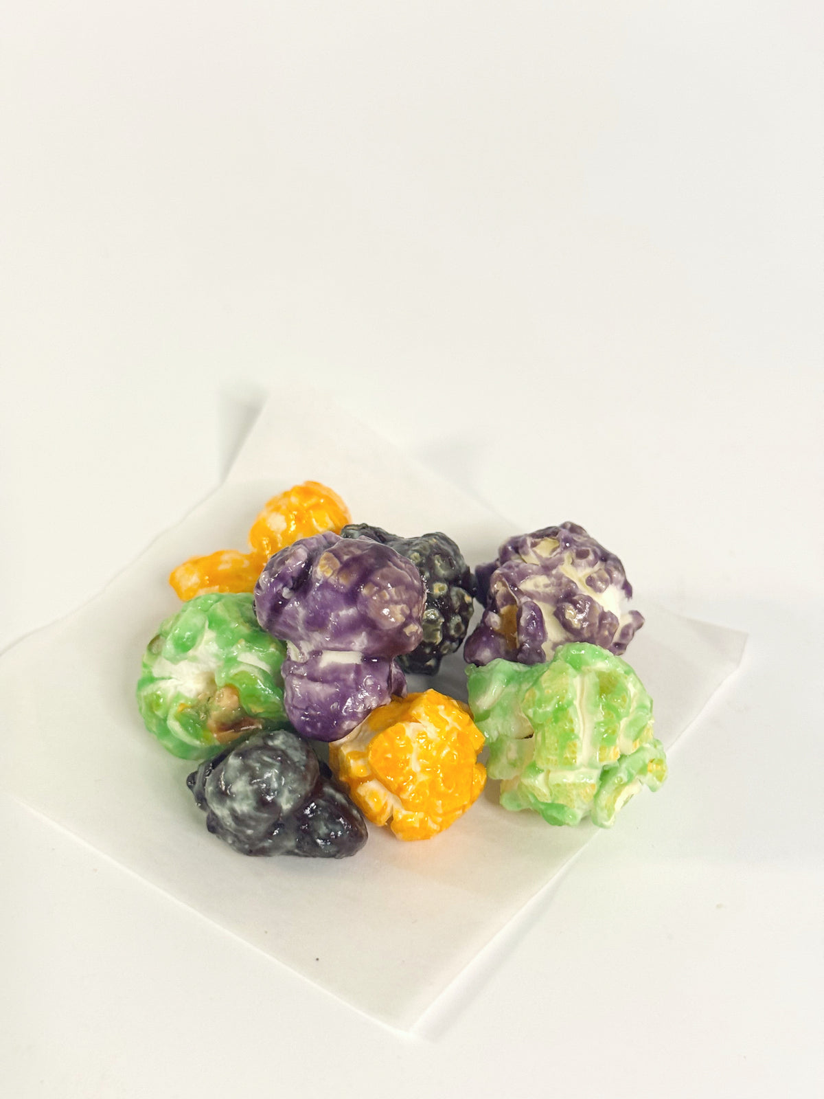 Colorful candy pieces on a white plate with a white background