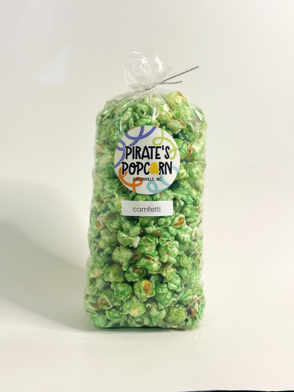 Bag of green popcorn with 'Pirate's Popcorn' label on a white background