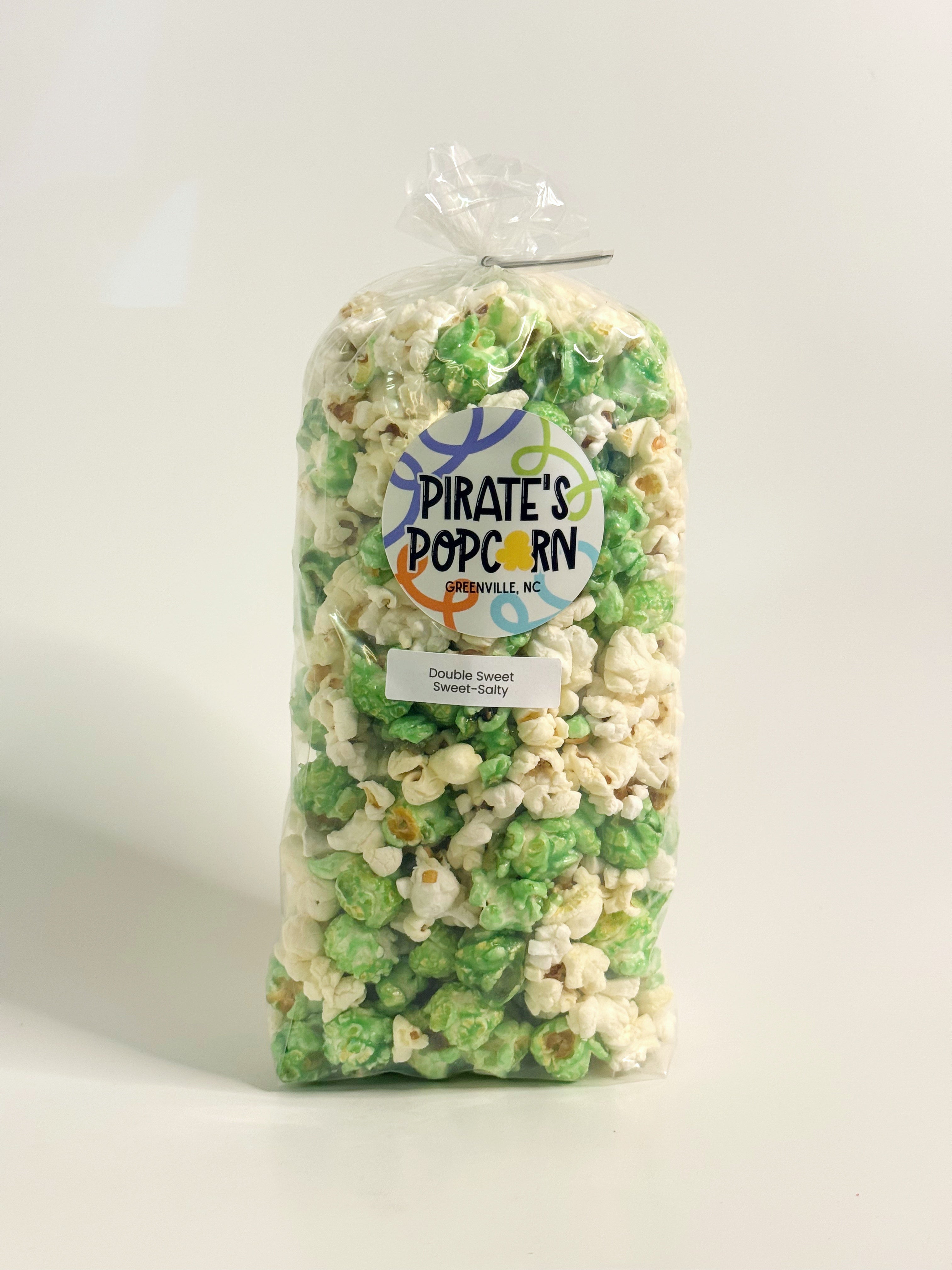 Bag of green and white popcorn with a 'Pirate's Popcorn' label on a white background gourmet popcorn gift bag