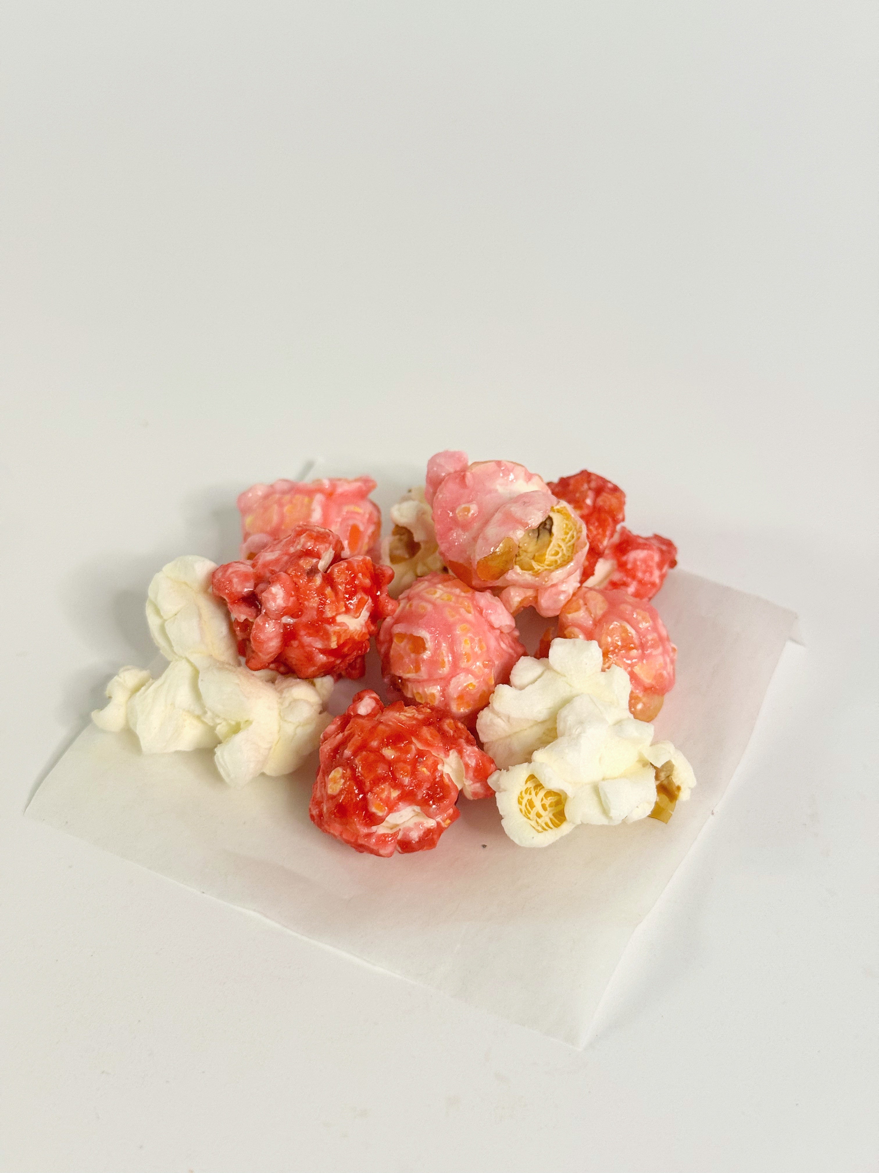 Assorted popcorn on a white plate with a light gray background gourmet popcorn gift bag