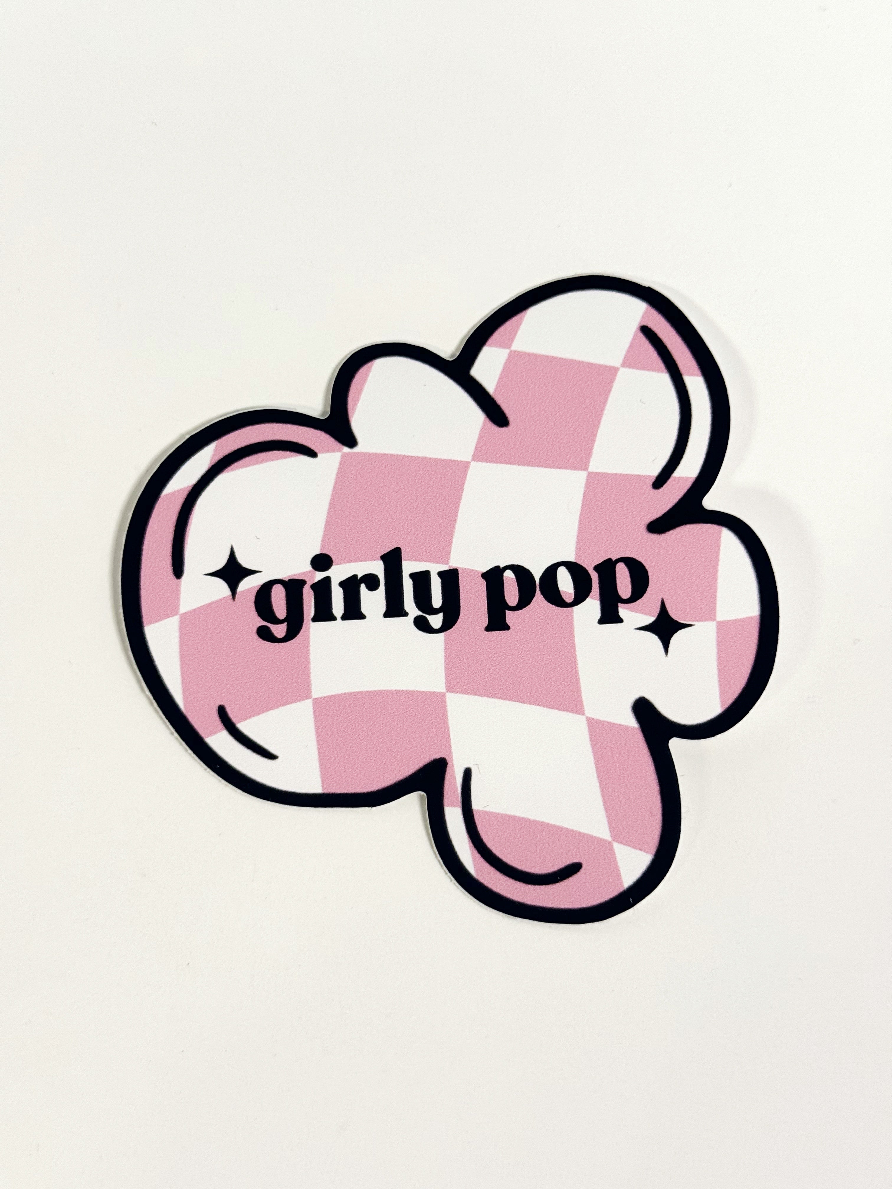 Sticker with pink and white checkered design and 'girly pop' text on a light gray background