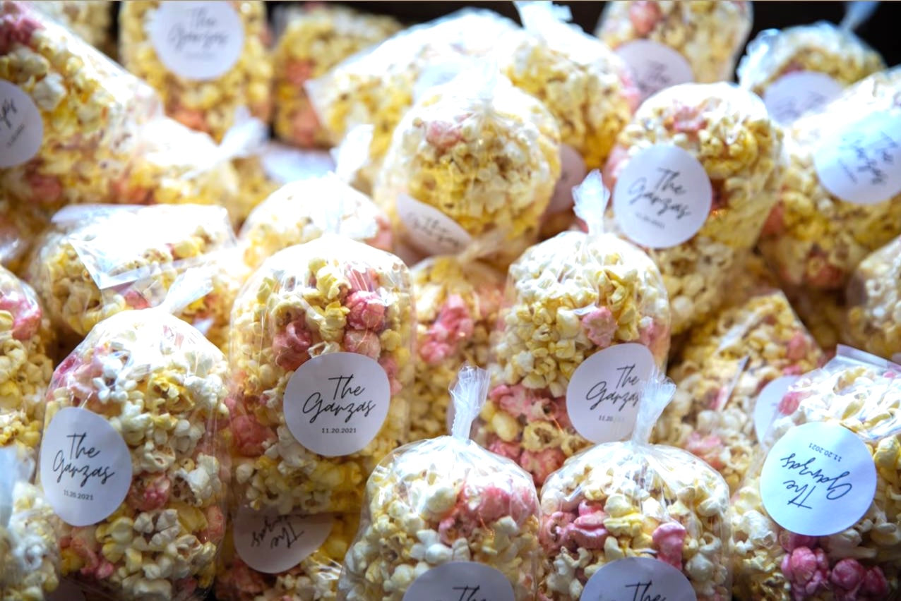 Popcorn balls with decorative toppings and labels on a table gourmet popcorn gift catering